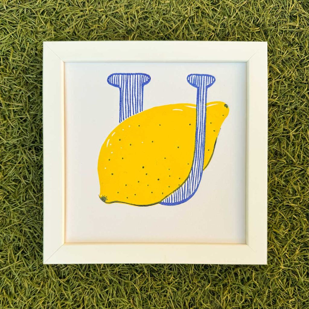 Framed 6x6 inch U-Lemon original art print displayed in a modern UK home.