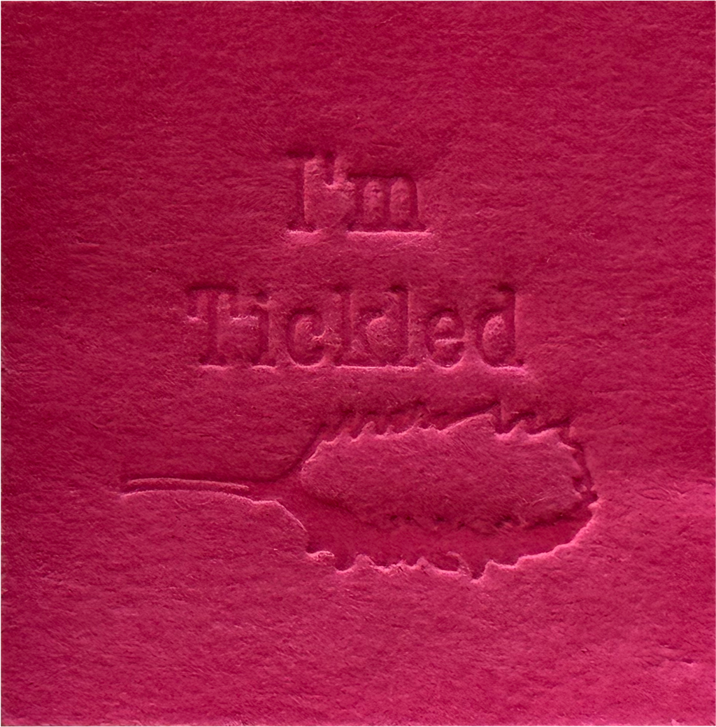 Surface Detail of original, minimalist, hand-embossed pink art card featuring the fun message ‘I’m Tickled’