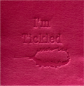 Surface Detail of original, minimalist, hand-embossed pink art card featuring the fun message ‘I’m Tickled’