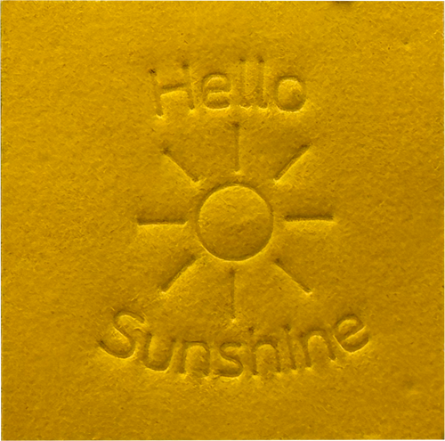 Surface Detail of original, minimalist, hand-embossed yellow art card featuring the positive message ‘Hello Sunshine’